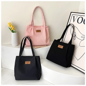 Minimalist canvas tote bags in pink and black displayed with stylish lifestyle props