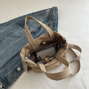 Khaki nylon bucket bag with adjustable strap and casual tote design for daily commute