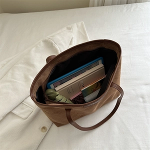 Brown corduroy tote bag for women showing large capacity for books and tablet