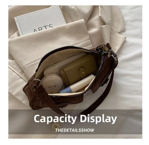 Top view of large capacity dark brown suede baguette bag showing spacious interior with essentials