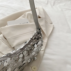 Silver sequin shoulder bag with leather strap and zipper closure in a trendy 2025 style