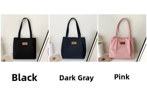 Three minimalist canvas tote bags in black, grey, and pink with leather logo patch detail