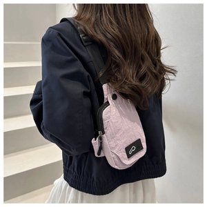 Light purple nylon crossbody chest bag with adjustable black strap shown on a model