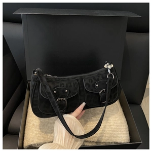 Detail of black leopard print suede underarm bag with double buckles in a gift box