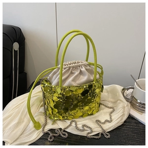 Detailed view of neon green sequin bucket bag with satin drawstring and silver chain strap