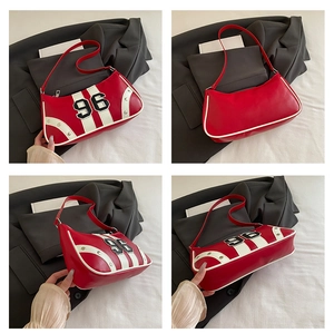 Detail view of red racing underarm bag showing front, back and side with rivet accents