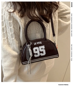 Detail of vintage dark brown bowling bag with Los Angeles lettering and chain charm