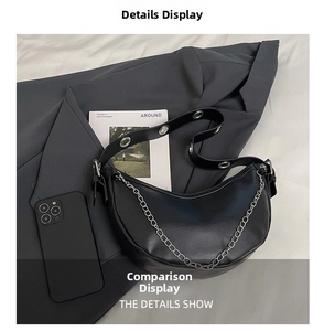 Close-up of black crescent bag featuring litchi texture and silver chain decoration