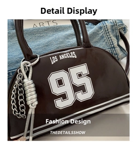 Detail of a brown leather crescent bag with Los Angeles 95 print and silver chain