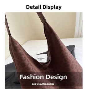 Close-up of leopard print shoulder bag showing suede texture and wide strap joint