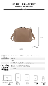 Detailed view of khaki canvas shell bag showing dual zippers and specific dimensions