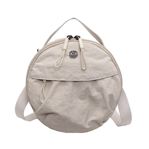 Beige nylon round crossbody bag with adjustable strap and front zipper pocket