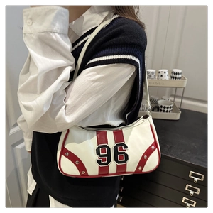 Detail of vintage racing style underarm bag with red stripes and number 96 embroidery