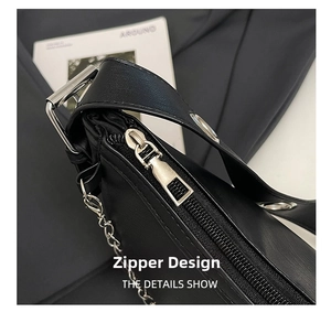 Detail view of the silver metal zipper and hardware on this black leather hobo bag