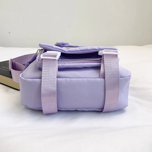 Purple nylon messenger bag with transparent PVC compartment and white buckle strap