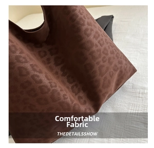 Close-up of the large leopard print tote bag showing the soft suede-like fabric texture