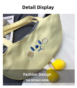 Close-up of yellow canvas bag featuring cute cartoon embroidery and 3D plush feet detail