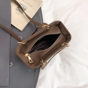 Deep brown quilted tote bag with gold hardware and spacious interior for urban commuting