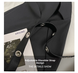 Close-up of black leather strap with silver metal eyelets on a crossbody tote bag