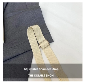 Close-up of cream canvas strap with adjustable gold metal buckle for bags