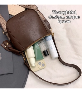 Detail view of coffee brown PU leather bag showing interior space and wide strap