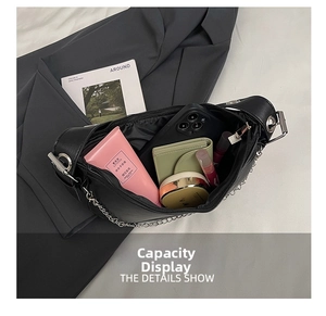 Interior view of black crescent bag showing storage capacity for phone and wallet