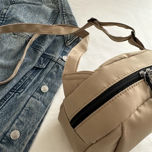 Beige lightweight quilted nylon shell bag with black zipper for casual crossbody wear
