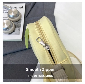 Detail view of smooth silver metal zipper and durable nylon fabric on yellow crossbody bag