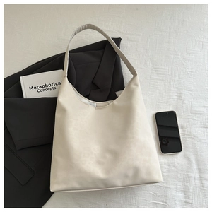 Minimalist beige tote bag showing large capacity for daily commute with smooth leather texture