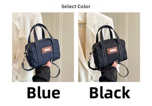 Detail view of blue and black denim handbags with leather patches and metal hardware