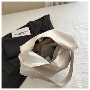 Detailed internal view of an off-white tote bag showing high storage capacity and magnetic closure