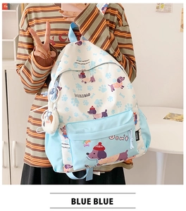 Detail of light blue cartoon backpack featuring dachshund prints and soft plush charm
