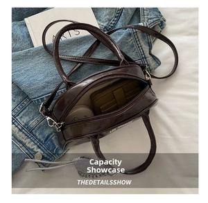 Top view of chocolate leather Boston bag showing interior capacity for daily essentials