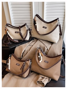 Detail of vintage canvas tote bags in two sizes with leather trim and ethnic beads
