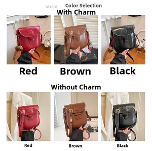 Collage of mini vintage saddle bags in red, brown, and black with strawberry charms