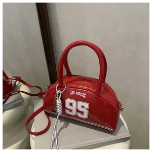 Detail of red Los Angeles 95 bowler bag with glossy finish and silver rope charm decoration