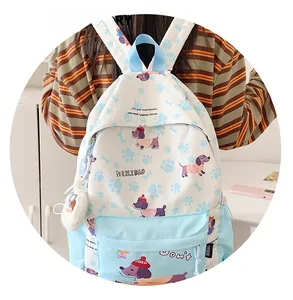 Close-up of cute cartoon puppy print on light blue backpack with white plush charm