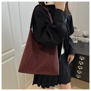Detail of burgundy leopard print hobo bag with wide shoulder strap in soft suede texture