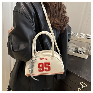 Close-up of a white vintage PU handbag with red Los Angeles print and metal chain detail