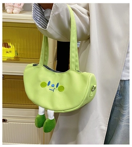 Green canvas crossbody bag featuring cute cartoon face embroidery and 3D plush legs detail