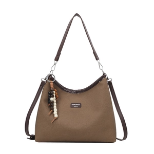Brown canvas tote bag with leather straps and decorative wooden bead charm accessory