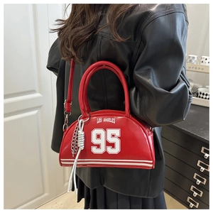 Detail of red shiny leather bowling bag featuring Los Angeles print and metal chain charm