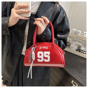 Close-up of red PU leather bag with white Los Angeles print and silver chain tassel