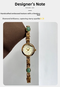 Detail of luxury gold quartz watch featuring emerald stone accents and GEDI logo dial
