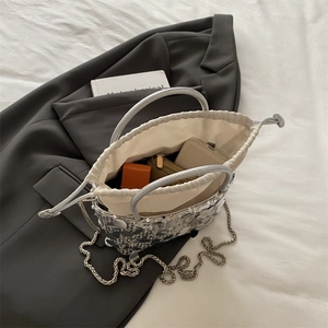 Chic silver sequin bucket bag with drawstring closure and silver chain strap