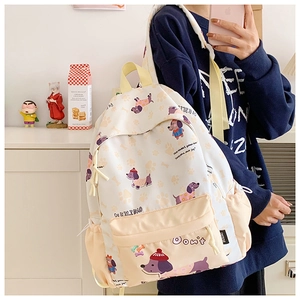 Detail of cute cartoon backpack showing durable material and side storage pocket