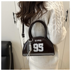 Detail of dark brown glossy bowling bag with Los Angeles print and silver chain link