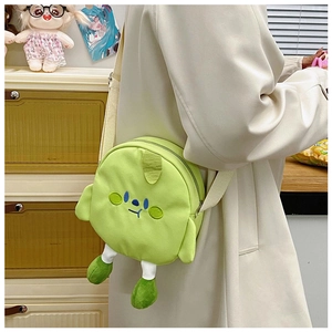Detail of cute green canvas crossbody bag featuring 3D plush legs and embroidery