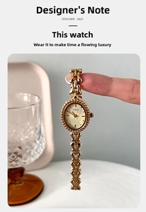 Detail of vintage gold jewelry watch with oval dial and heart-shaped chain bracelet
