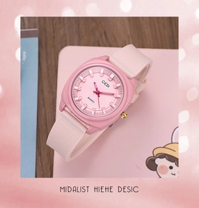 Detailed view of GEDI pink quartz watch with silicone strap on a minimalist desk